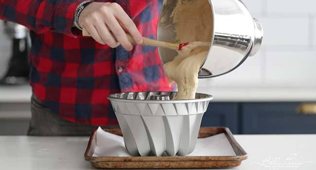 pouring batter into a bundt pan