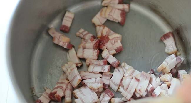 cooking thick-cut bacon in a pan