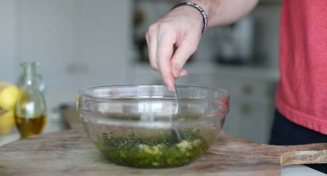 mixing together an herb chimichurri