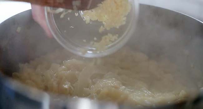 adding garlic to caramelized onions