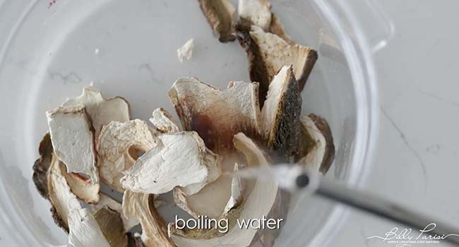 adding hot water to porcini mushrooms