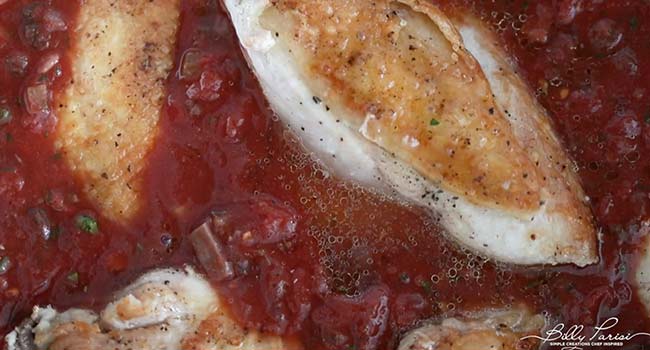 adding chicken to a cacciatore sauce