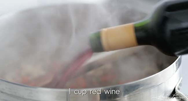 adding wine to a pan