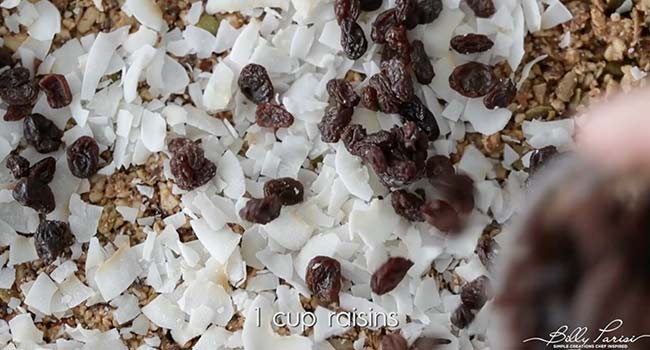 adding raisins and coconut to granola