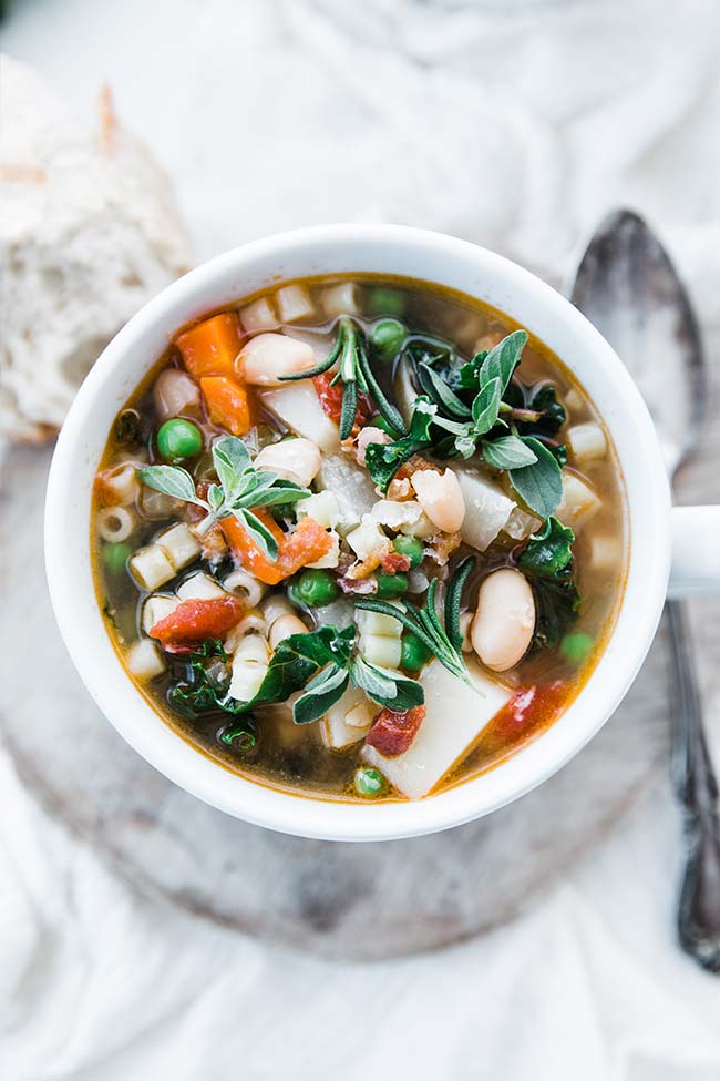 minestrone soup recipe in a bowl served up with fresh herbs