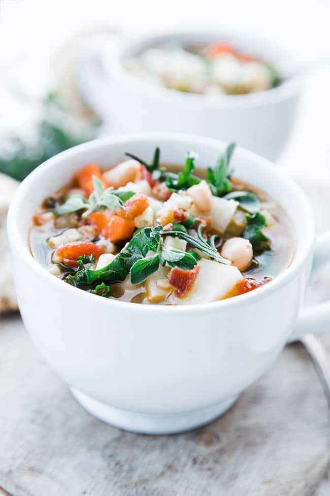 vegetable minestrone soup recipe with beans, kale, carrots and oregano in a cup