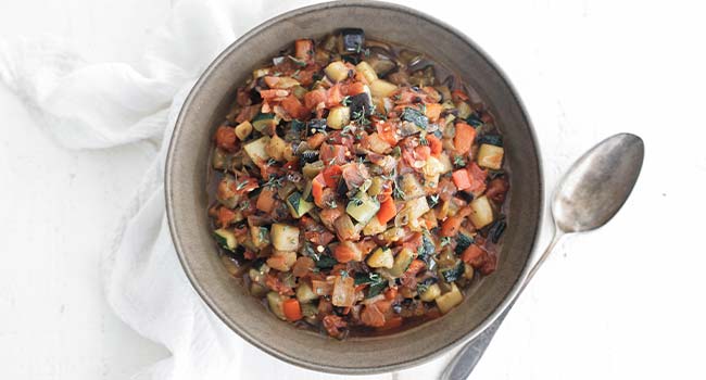 ratatouille in a bowl with fresh thyme