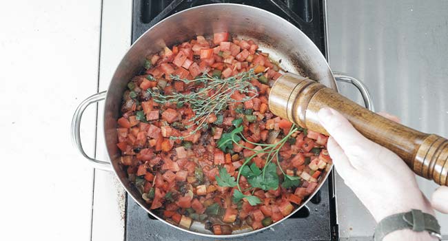 tomatoes with herbs in a pot