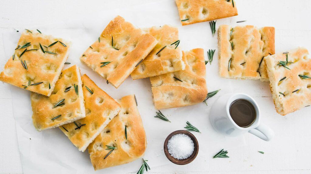 focaccia bread sliced up and served with salt and herbs