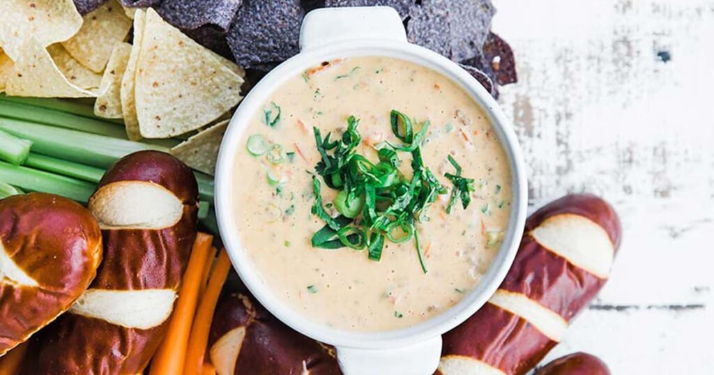dip recipe topped off with herbs and served with dippers