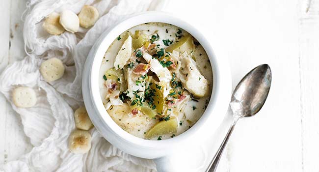 fish chowder in a bowl with oyster crackers