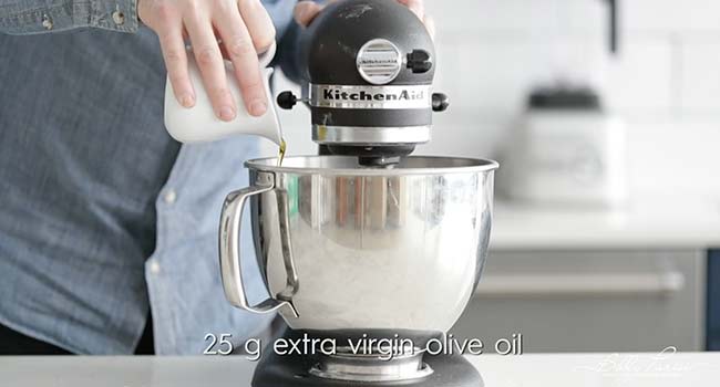 adding flour to a stand mixer