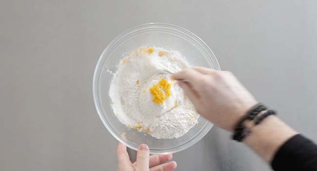 mixing zest into flour