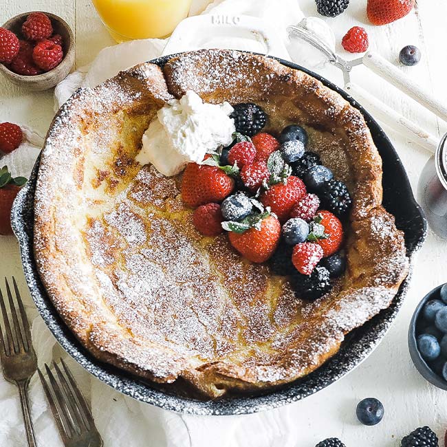 dutch baby pancaked with berries and whipped cream