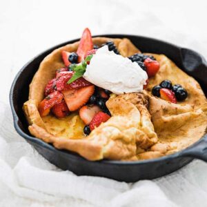 Dutch Baby pancake with whipped cream and fresh berries