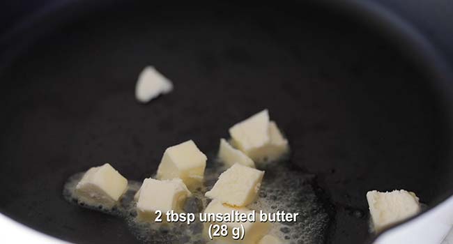 putting butter pads in a hot cast iron skillet