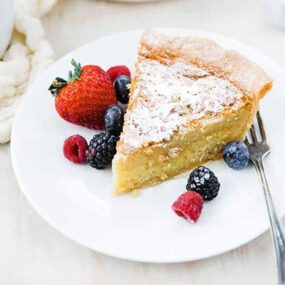 chess pie recipe on a plate with fresh berries
