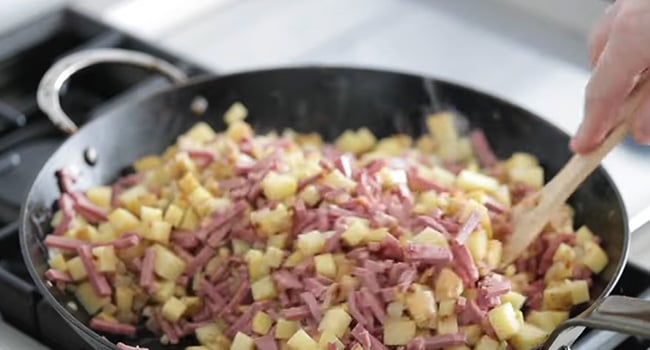 potatoes and corned beef in a pan