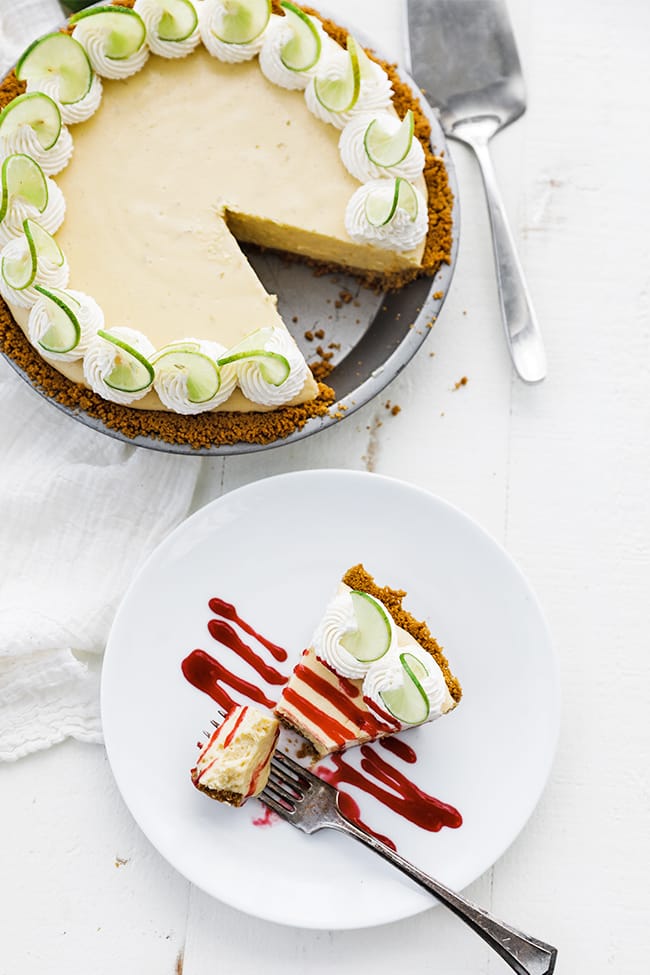 whole key lime pie with a slice of key lime pie on a plate