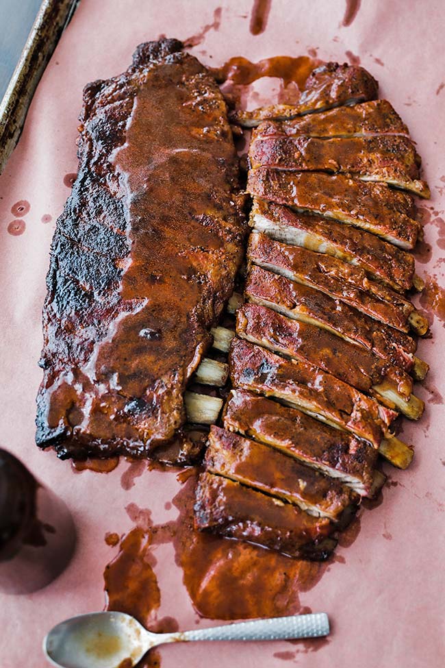 2 slabs of smoked ribs with sauce on peach paper