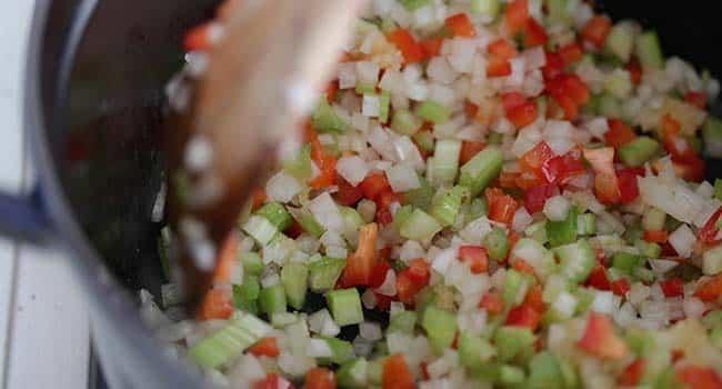 sauteing onions and peppers in a pot