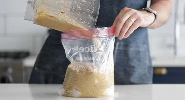 adding a marinade to a bag with chicken