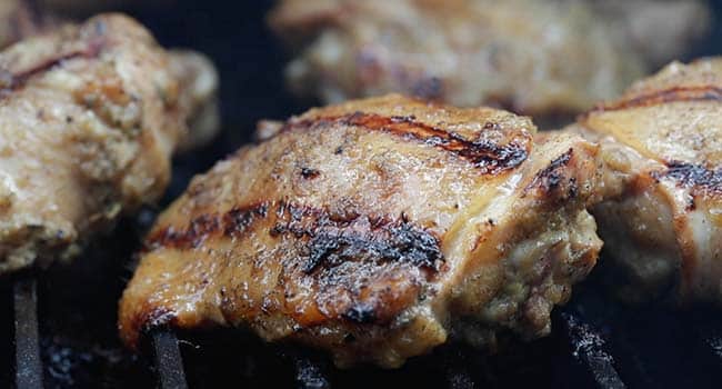 grilled jerk chicken on a grill