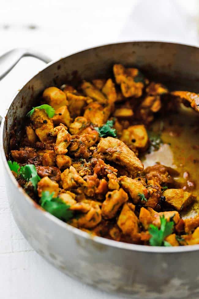 large rondeau pot of chicken curry with cilantro