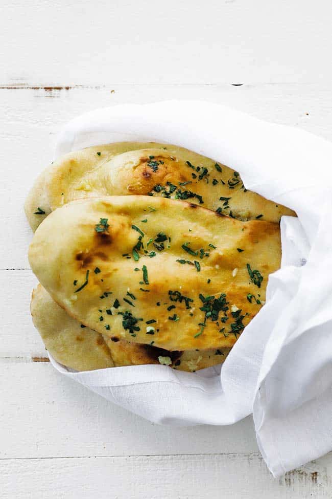 flattened indian bread with parsley in a sak cloth