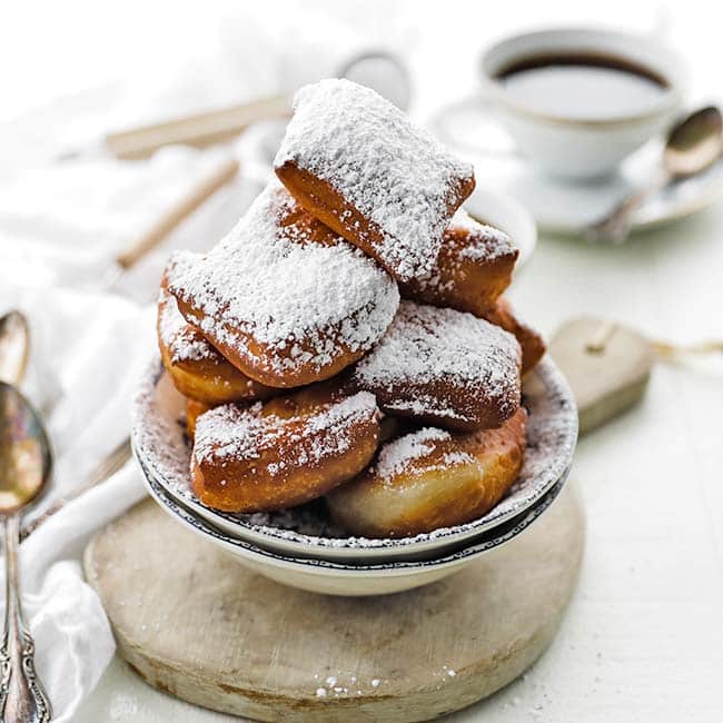 beignet donuts covered in powdered sugar and served with coffee