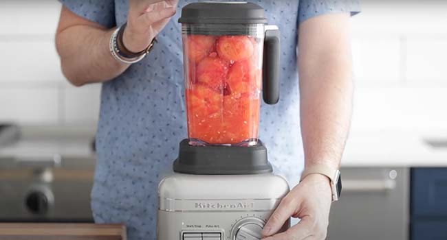 pureeing tomatoes in a blender