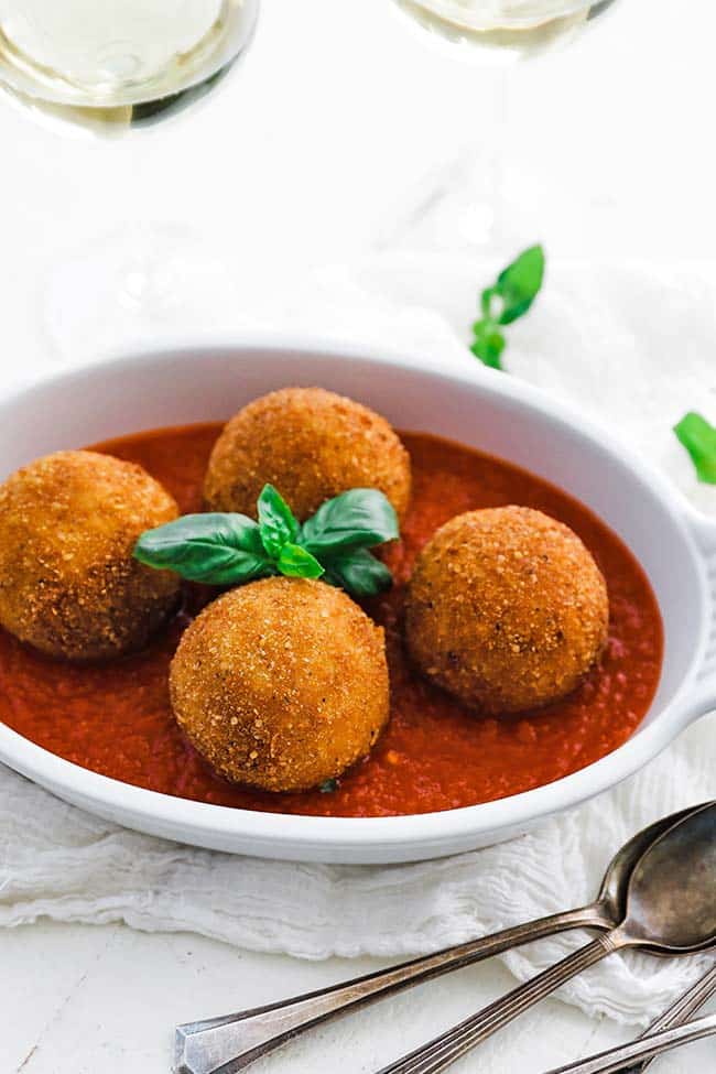fried arancini balls with fresh basil and pomodoro sauce
