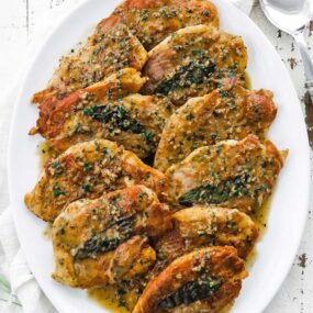 chicken saltimbocca with white wine sauce on a platter