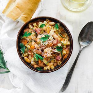 bowl of pasta and beans with fresh herbs