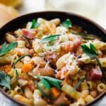 bowl of pasta e fagioli with carrots and herbs