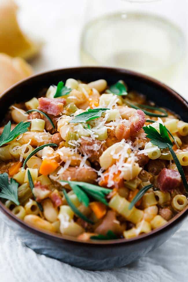 bowl of pasta e fagioli with carrots and herbs