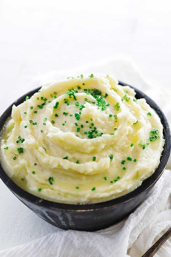large bowl of yukon mashed potatoes and melted butter
