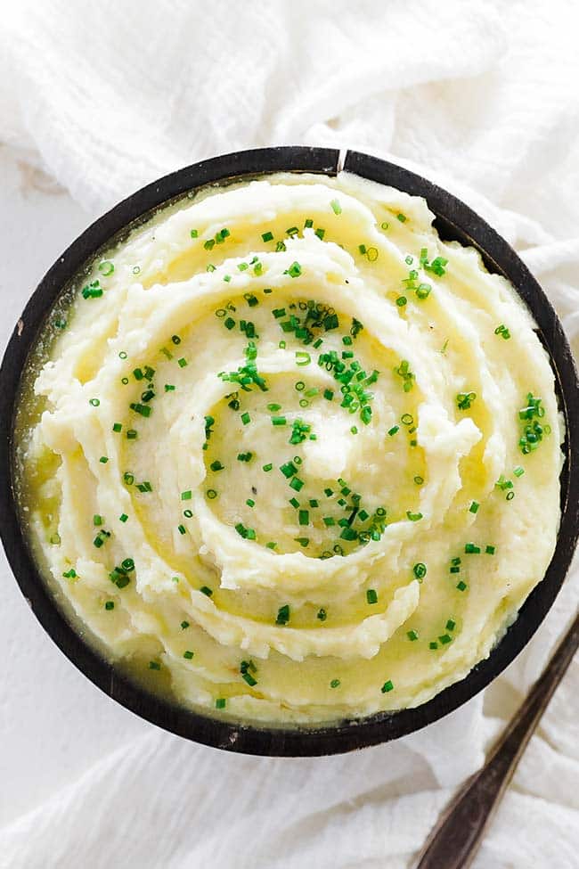 roasted garlic mashed potatoes with melted butter and chopped herbs