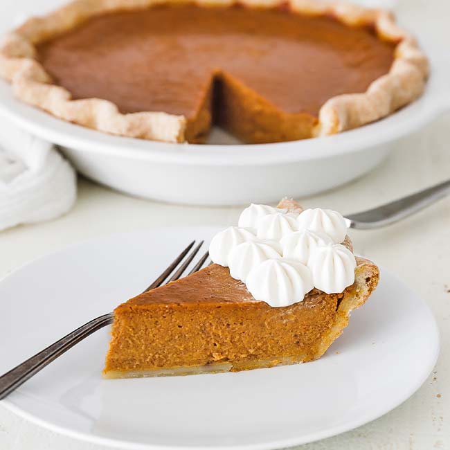 slice of pumpkin pie with whipped cream