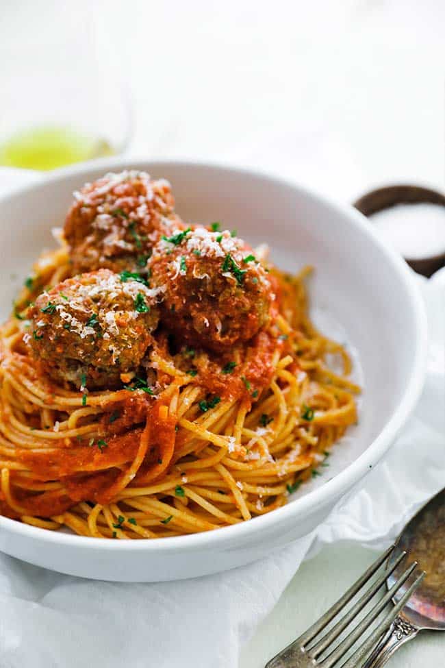 noodles coated in a pomodoro sauce with meatballs on top