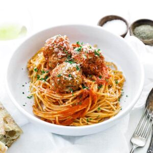 bowl of spaghetti with tomato sauce and meatballs