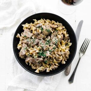 bowl of egg noodles with beef stroganoff and sauce