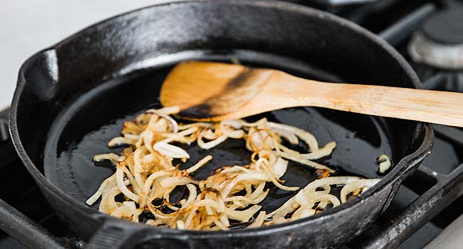 sautéing onions in a pan