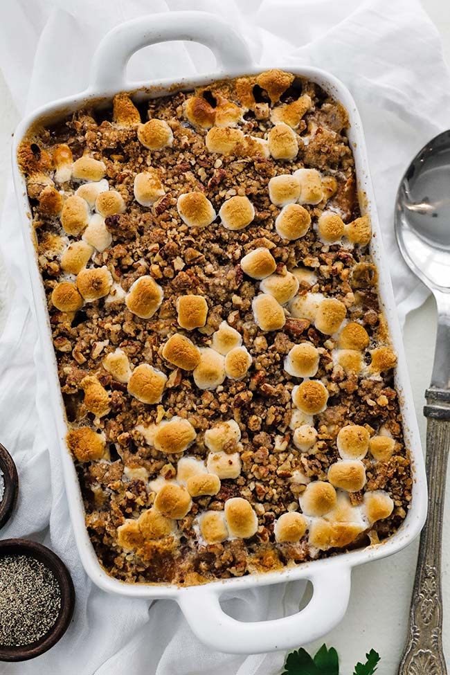 white rectangle dish with a sweet potato casserole and pecan topping