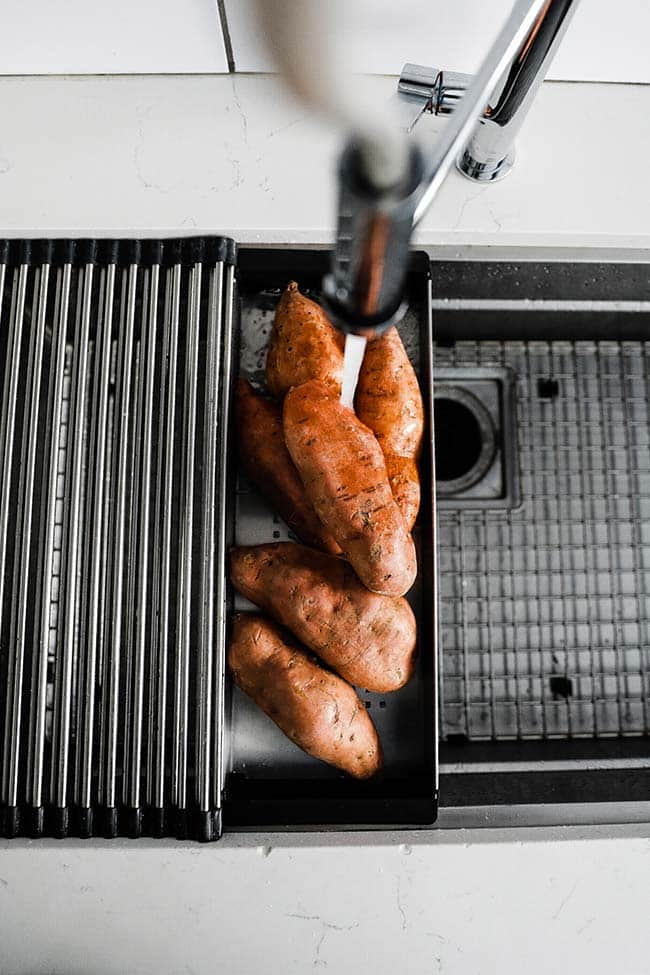 rinsing off sweet potatoes with water in the franke chef center