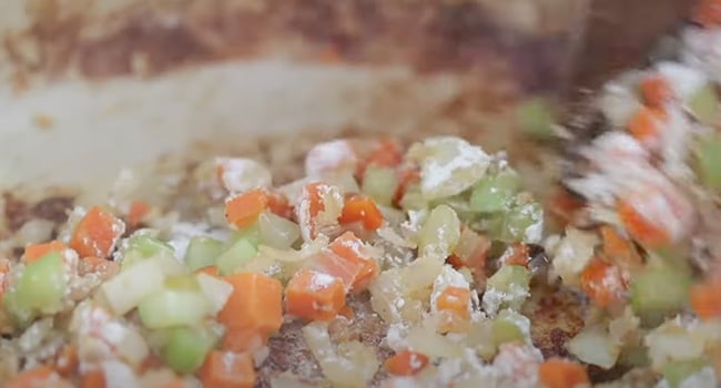 stirring flour into vegetables