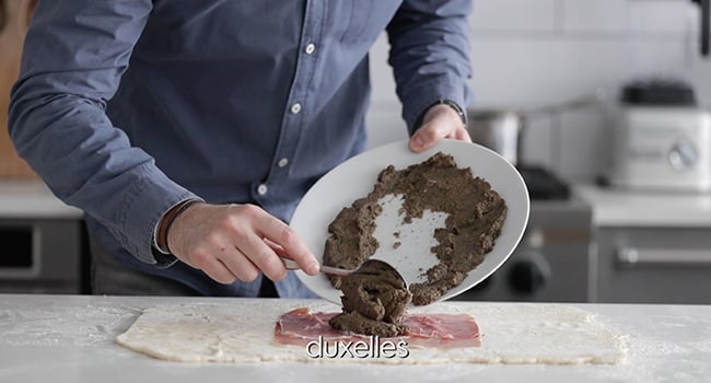 adding duxelles to prosciutto ham