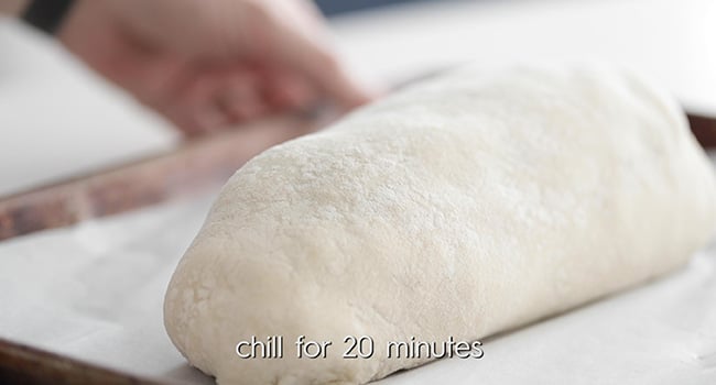 adding beef wellington to a sheet tray