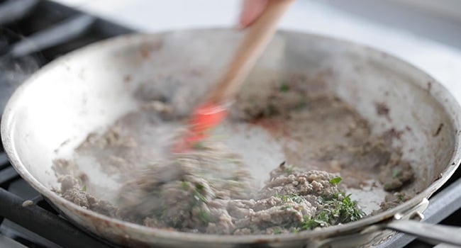 folding herbs in duxelles