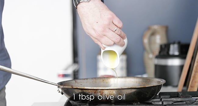 adding oil to a pan